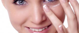 girl applying ointment to her eyes